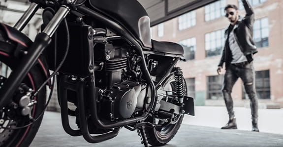 guy_opening_garage_door_with_a_motorcycle_in_the_garage_575x300