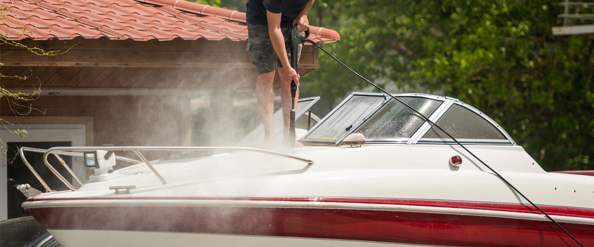 May 2 blog Close-up of man cleaning boat.